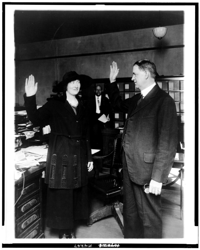 Training a policewoman. The newest recruit to the District of Columbia's little band of sleuths (f(emale)) is solemnly sworn into her office by Edwin Hesse, chief clerk of the police LCCN91796412