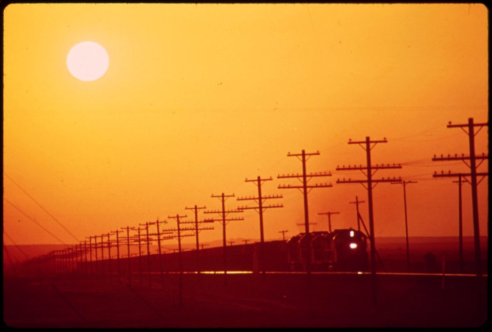 Transmission-lines-and-railroad-near-salton-sea-district-of-los-angeles-smog-obscures-the-sun-may-1972 6990241824 o