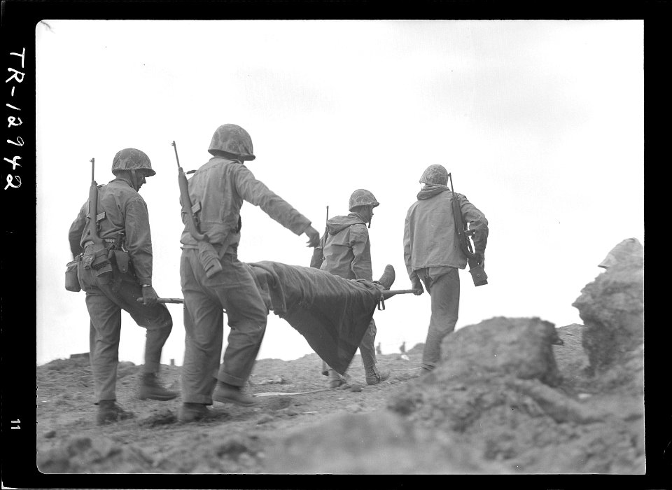 Transportation of wounded on Iwo Jima. A wounded Marine being evacuated from front lines for medical treatment. - NARA - 520734