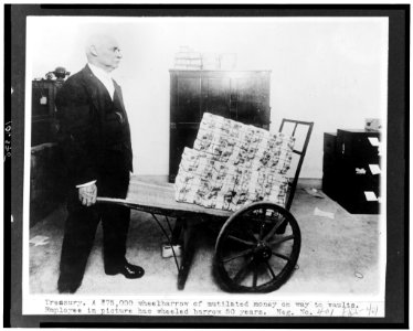 Treasury. A $75,000 wheelbarrow of mutilated money on way to vaults. Employee in picture has wheeled barrow 50 years LCCN93502600