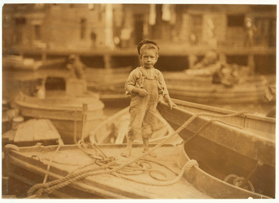Truant hanging around boats in the harbor during school hours. LOC nclc.04554