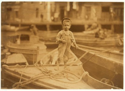 Truant hanging around boats in the harbor during school hours. LOC nclc.04554