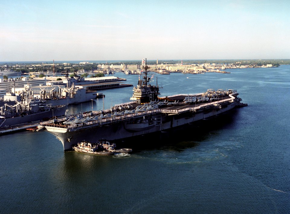 Tugs assist USS Ranger (CV-61) at Pearl Harbor on 8 March 1993