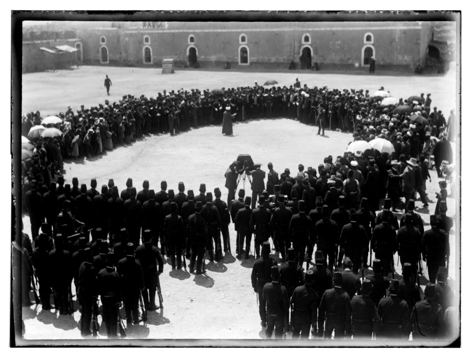 Turkish military WWI. Man being photographed in a circle of people with Turkish army LOC matpc.07443