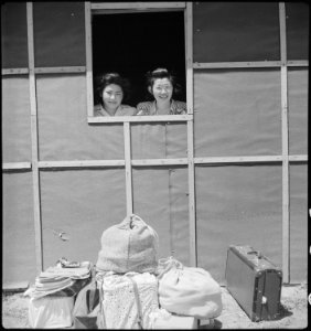 Turlock, California. These two girls peer out of a window in their quarters just after their arriva . . . - NARA - 537649