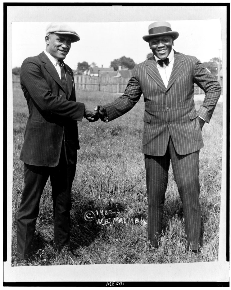 Tut Jackson (left) and Jack Johnson shaking hands LCCN92510475