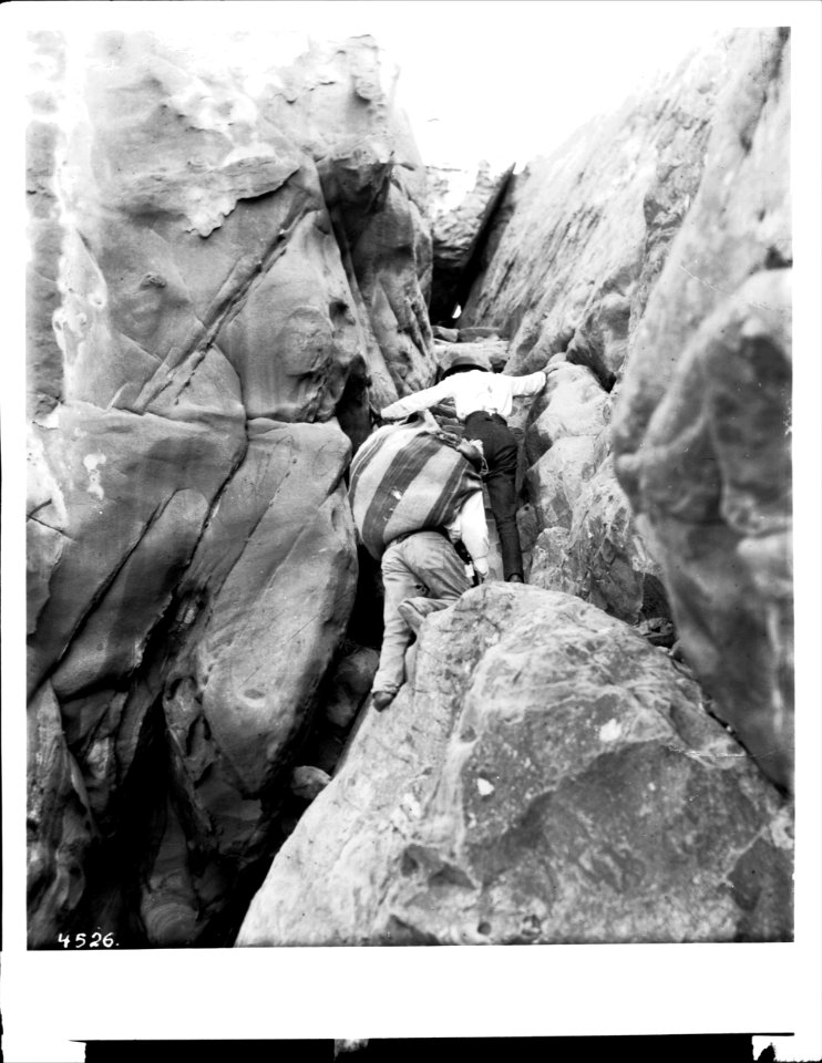 Two Acoma Indian men climbing up the Acoma Trail, 1886 (CHS-4526)