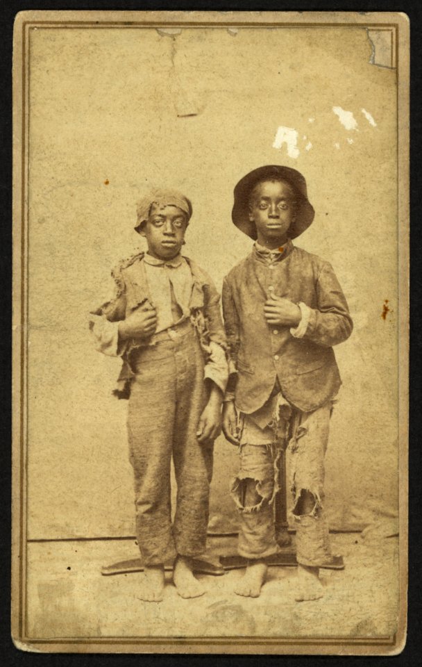 Two African American boys, full-length portrait, facing front) - J. R. Shockley, photographer, West Side of Main St., Hannibal, Mo LCCN2010647915