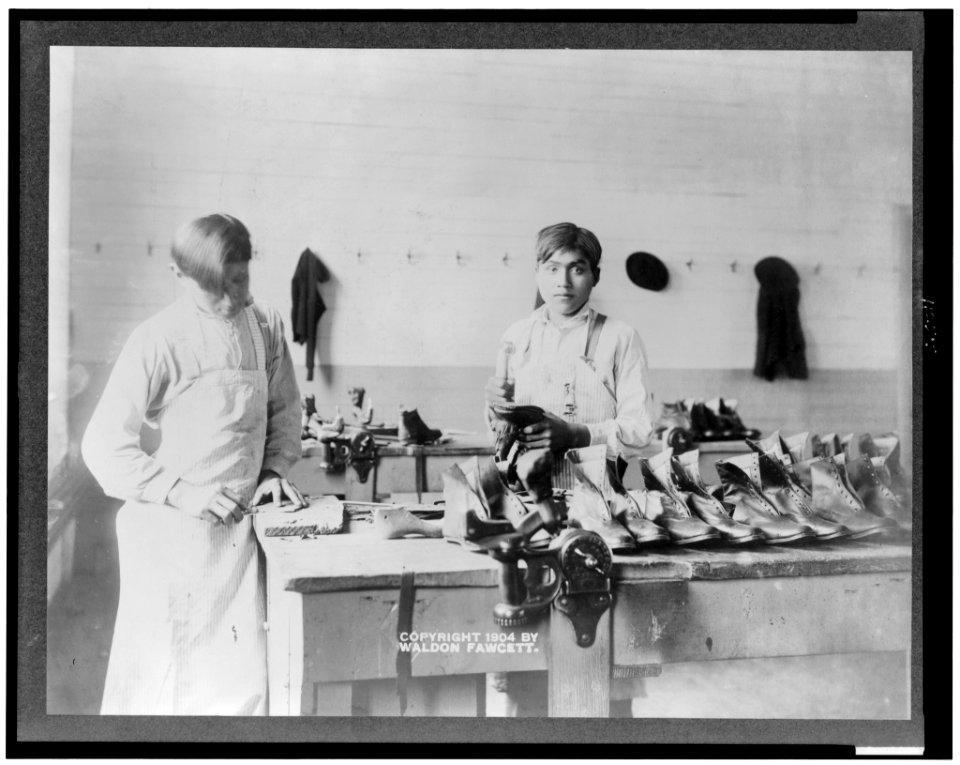Two boys making or repairing shoes at Carlisle Indian School LCCN95510302