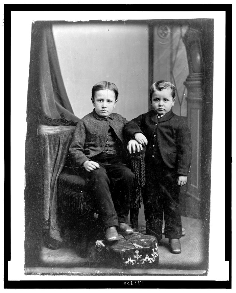 Two boys, one seated, one standing LCCN2006688333