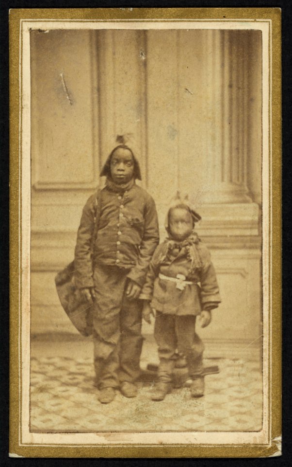 Two African American boys facing front, wearing hats and jackets) - from Jos. M. Herron & Co., Troy, N.Y LCCN2010647914