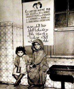 Two Arabian children have just received their daily milk ration, Algeria, 1943 (27325808250) photo