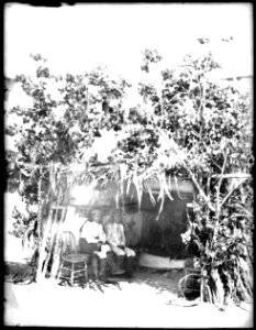 Two Acoma Indian men sitting before the sacred kisi of San Esteban, Acoma Pueblo, 1886 (CHS-4532)