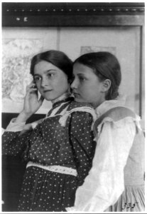 Two girls from a Washington, D.C., school on a class visit to the Library of Congress, looking at an exhibit of relief or wood engravings, one with her chin on shoulder of the other LCCN2001703710