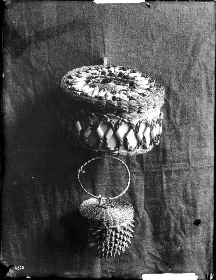 Two Indian baskets displayed against a cloth backdrop, ca.1900 (CHS-4829)