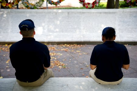 Two law enforcement explorers sitting at the National Law Enforcement Officers Memorial photo