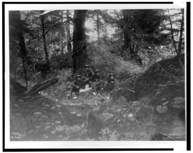 Two men and two women seated in forest in Alaska, 1899) - Curtis LCCN2002706855
