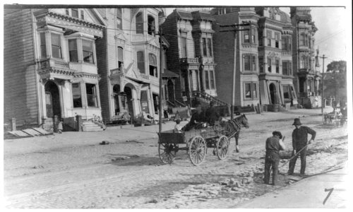 Two men cleaning street, horse-drawn wagon and damaged buildings in the background, after the 1906 San Francisco earthquake LCCN2007681301 photo