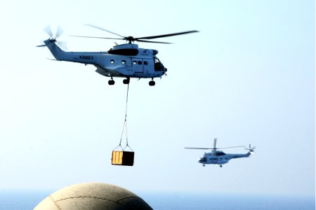 Two Military Sealift Command SA-330J Puma helicopters participate in a replenishment at sea with the aircraft carrier USS George H.W. Bush (CVN 77) in the Persian Gulf Aug. 27, 2014 140827-N-CZ979-006