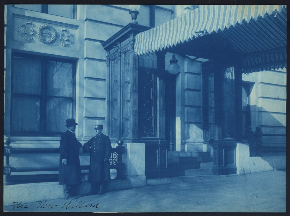 Two men, one a doorman, standing at the F. Street entrance to the Willard Hotel LCCN91482244