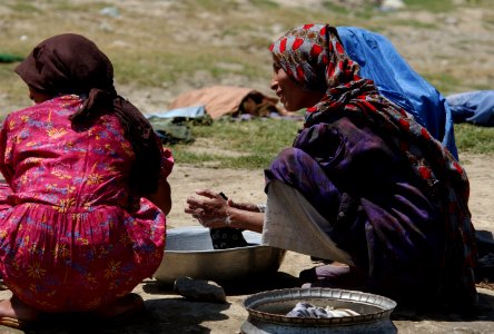 Two Local Afghanistan women wash clothes at an area located near the Kabul River in downtown Kabul DF-SD-04-08408