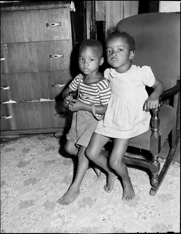 Two of Mrs. Beulah Wady's four children in living room of their five room house for which they pay $9 monthly.... - NARA - 540722