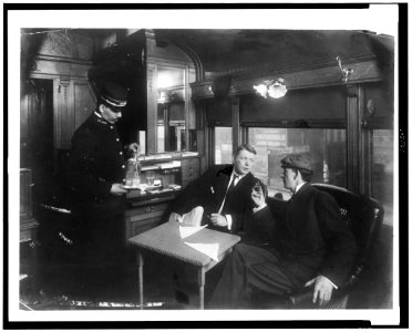 Two men being served drinks in buffet railroad car LCCN93505791