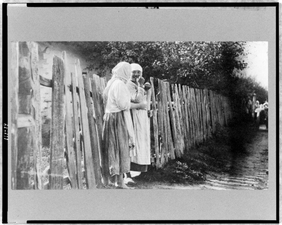 Two peasant women standing along wooden fence, Russia LCCN97517364