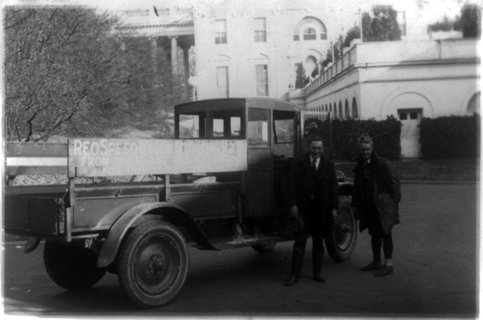 Two men standing next to a Reo truck, which brought Eskimo pie from Chicago to President Harding at the White House LCCN92520905