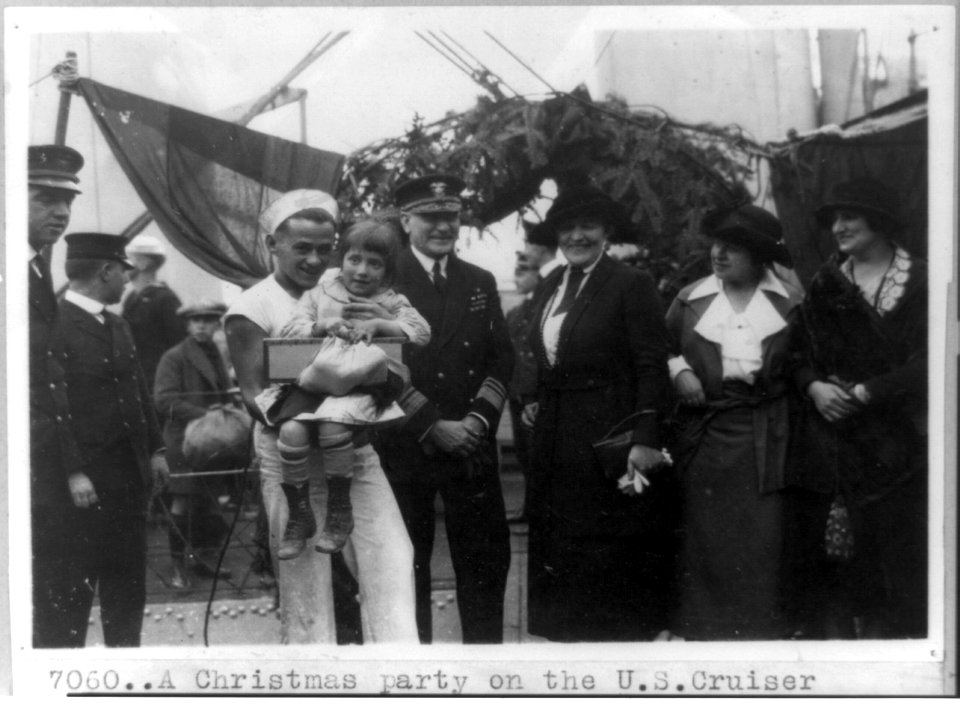 Two orphans with Near East Relief workers and sailors on board the U.S. cruiser Pittsburgh as guests of the officers for a Christmas party in the Bosporus LCCN91786356