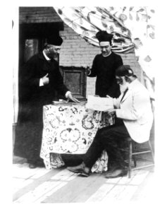 Two Los Angeles Plaza church priests with Don Antonio Coronel examining church records, ca.1885-1900 (CHS-3865) photo