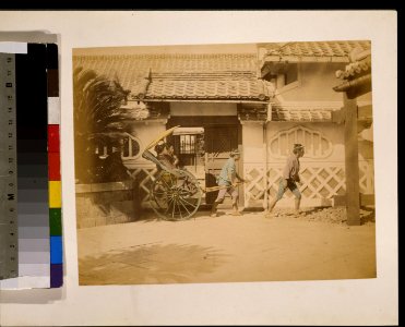 Two women riding in a rickshaw LCCN2009632877