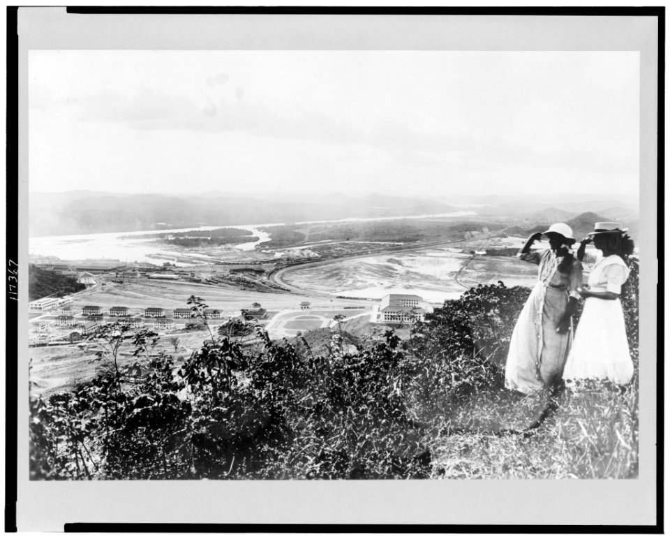 Two women, standing on hill, overlooking Pacific entrance to the Panama Canal, Balboa, Panama LCCN96522579