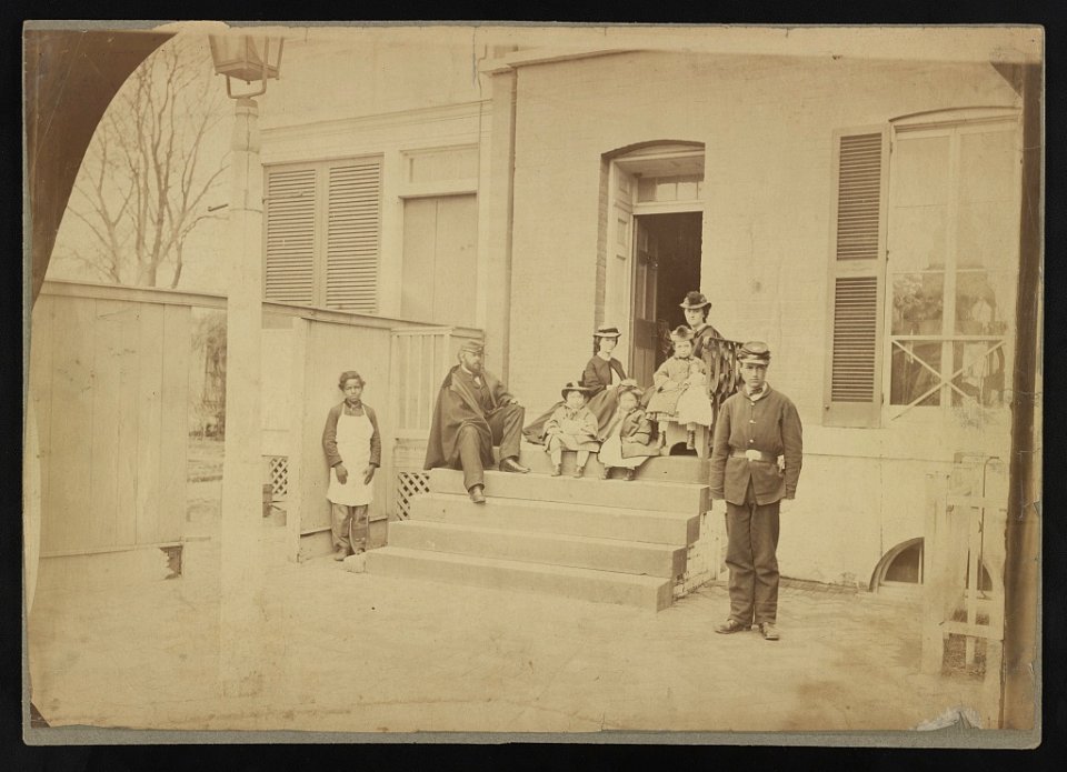 Two unidentified soldiers and others at the front steps of a house LCCN2012649141