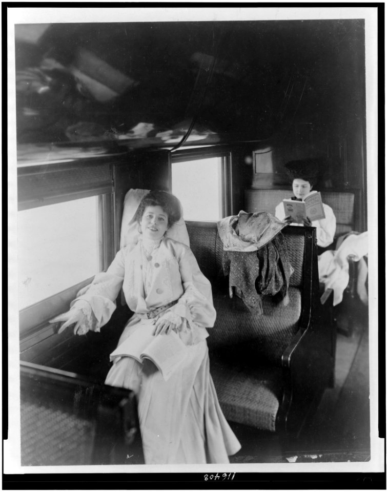 Two women reading in railroad passenger car LCCN96510253