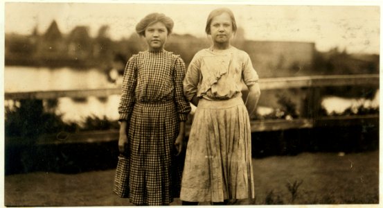 Two young spinners at the close of a week's work leaving the cotton mill in Easthampton, Mass. They work much longer hours than the burly tinsmith in photo -3033. LOC nclc.02629