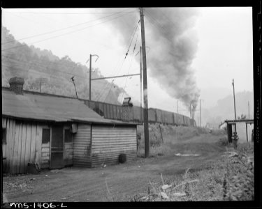 Typical house with coal cars in background. Kingston Pocahontas Coal Company, Exeter Mine, Welch, McDowell County... - NARA - 540784