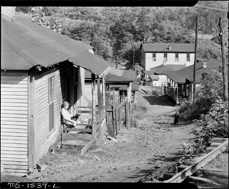 Typical houses and street. Comment of a miner, These houses were here when I was born and they're as worn out as I... - NARA - 540953