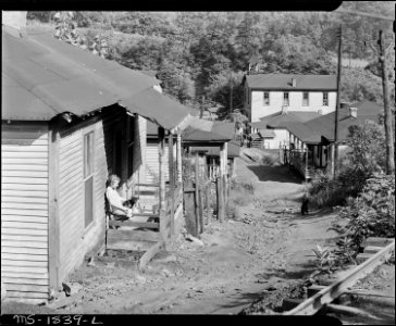 Typical houses and street. Comment of a miner, These houses were here when I was born and they're as worn out as I... - NARA - 540953