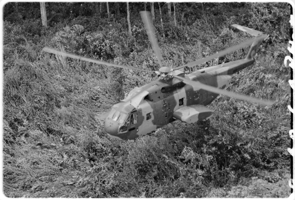 U.S. Air Force CH3E helicopter approaching landing zone in Southeast Asian jungle during operation Pony Express. - NARA - 542306