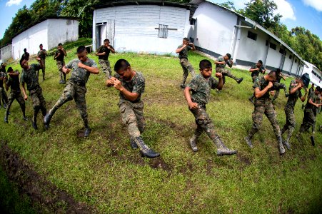 U.S. Marines assigned to a landing attack subsequent operations team conduct combat conditioning exchanges with Guatemalan service members during Southern Partnership Station (SPS) 2014 in Puerto Barrios 140819-N-XQ474-026