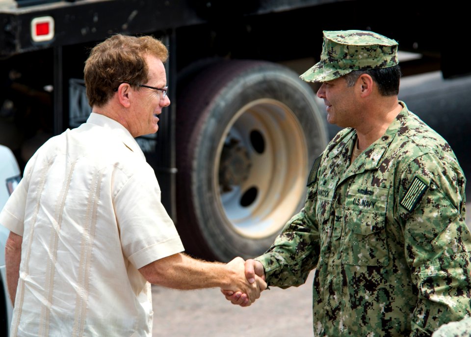 U.S. Ambassador to Honduras James D. Nealon, left, exchanges greetings with U.S. Navy Capt. Sam Hancock, the mission commander for Southern Partnership Station (SPS) 2014 operations aboard the joint high speed 140901-N-XQ474-002