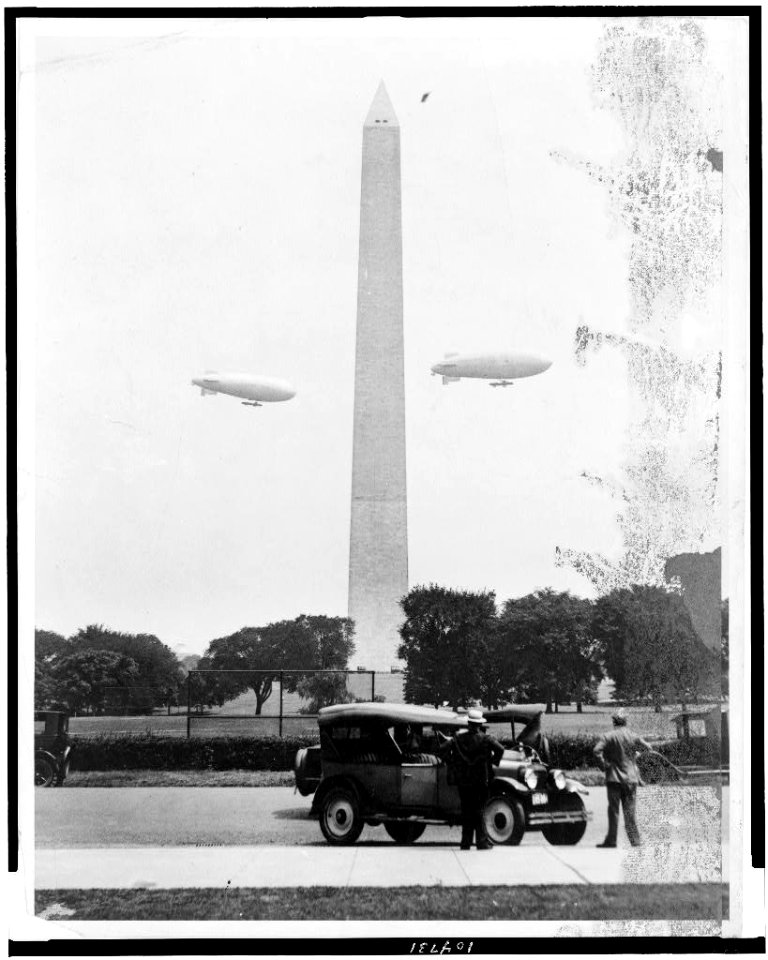 U.S. Army blimps, the T.C. 5 and T.C. 9 from Langley Field, Va. passing over the Washington Monument during a practice flight LCCN91482343