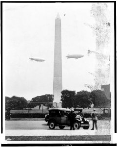 U.S. Army blimps, the T.C. 5 and T.C. 9 from Langley Field, Va. passing over the Washington Monument during a practice flight LCCN91482343 photo