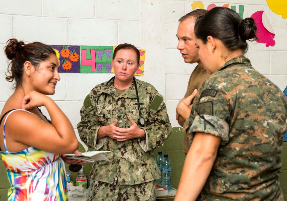 U.S. and Guatemalan service members, Ministry of Education teachers and Ministry of Health doctors and nurses tend to a Guatemalan patient at a medical civic action project (MEDCAP) in Puerto Barrios, Guatemala 140823-N-QY430-556