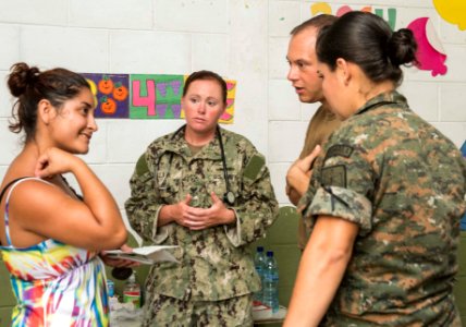 U.S. and Guatemalan service members, Ministry of Education teachers and Ministry of Health doctors and nurses tend to a Guatemalan patient at a medical civic action project (MEDCAP) in Puerto Barrios, Guatemala 140823-N-QY430-556