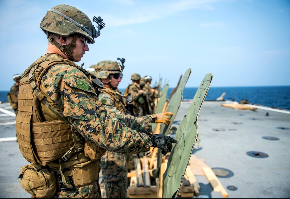 U.S. Marines assigned to Battalion Landing Team, 2nd Battalion, 5th Marine Regiment, 31st Marine Expeditionary Unit (MEU) grade targets during a live-fire exercise aboard the amphibious transport dock ship USS 140319-N-ZU025-208