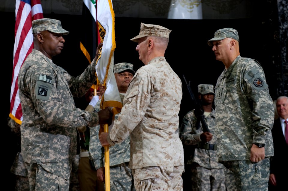 U.S. Army Gen. Lloyd J. Austin III, left, the incoming commander of U.S. Forces-Iraq (USF-I), accepts the command colors from U.S. Marine Corps Gen. Gen. James N. Mattis, the commander of U.S. Central Command 100901-N-TT977-288