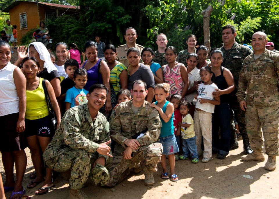 U.S. and Guatemalan service members, Ministry of Education teachers and Ministry of Health doctors and nurses take a group picture with Guatemalan patients at a medical civic action project (MEDCAP) in Puerto 140823-N-QY430-092