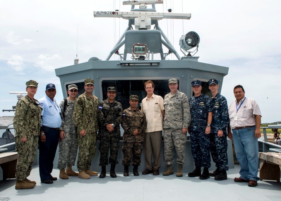 U.S. and Honduran military and government officials stand for a photo aboard the Honduran navy patrol boat FNH Morazan (1402) in Puerto Castilla, Honduras, Sept 140901-N-QY430-591